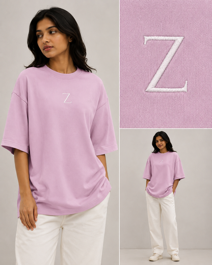 Zeroform , women oversized T-shirts Person wearing a pink oversized t-shirt with a white 'Z' logo, standing against a plain background.