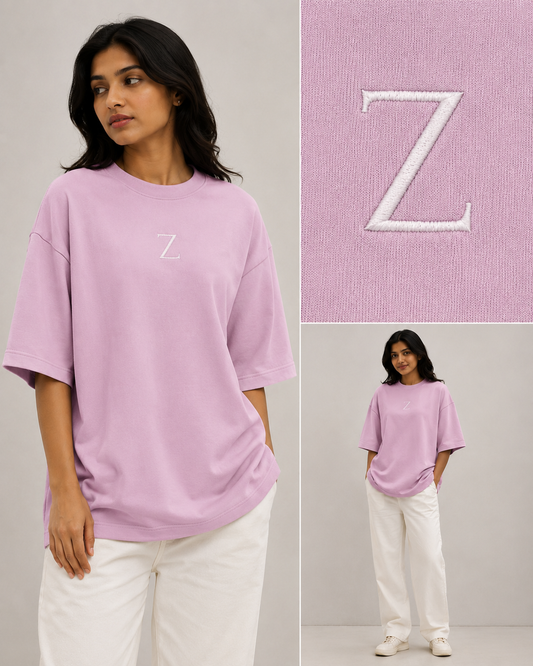 Zeroform , women oversized T-shirts Person wearing a pink oversized t-shirt with a white 'Z' logo, standing against a plain background.