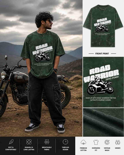 Person wearing a green 'Road Warrior' t-shirt with a motorcycle graphic, standing next to a motorcycle in a mountainous landscape.