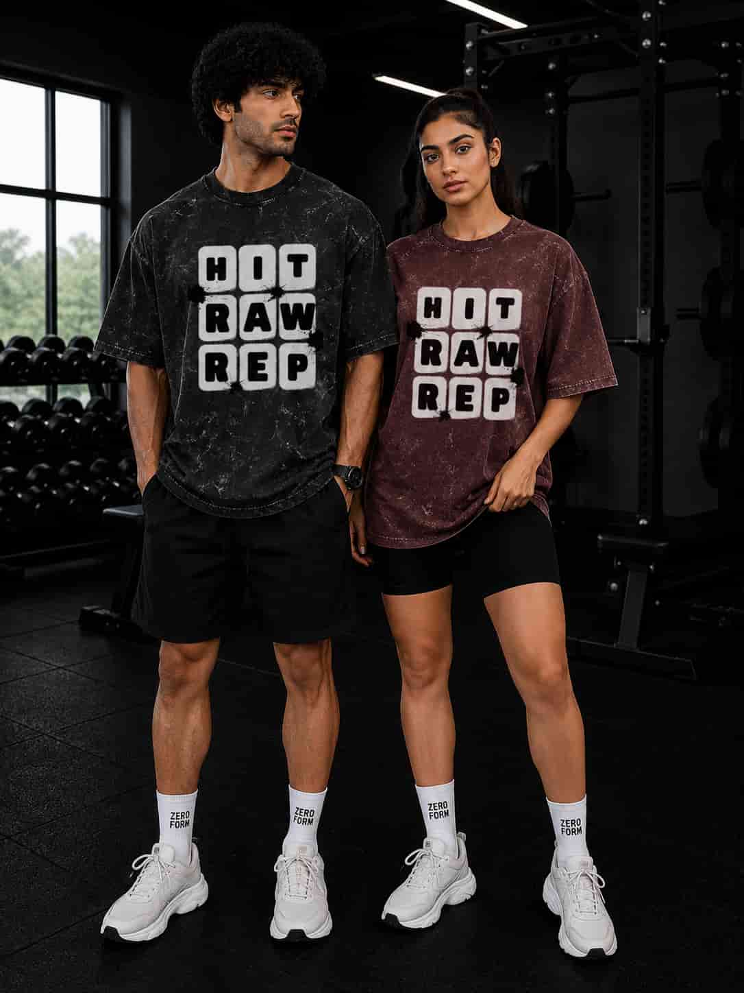 Zeroform Two people wearing matching 'HIT RAW REP' t-shirts in a gym setting.