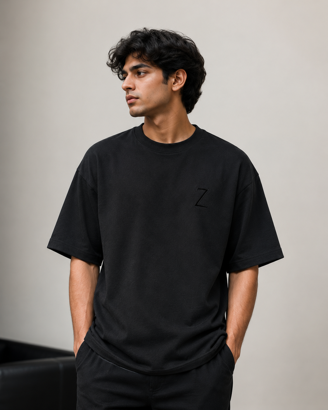 zeroform | Person wearing a black t-shirt with a logo on a plain background