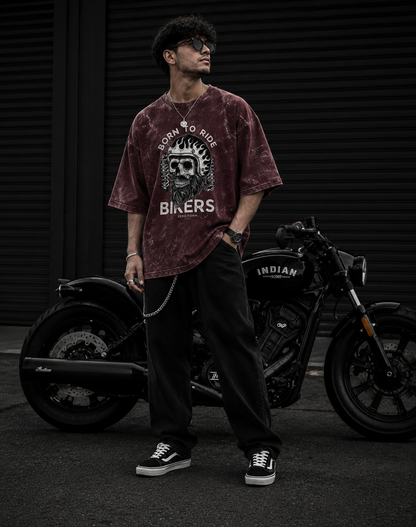 Zerofrom Born to Ride Oversized | 100% Cotton Acid Wash Person wearing a maroon t-shirt with a graphic design standing next to a motorcycle.