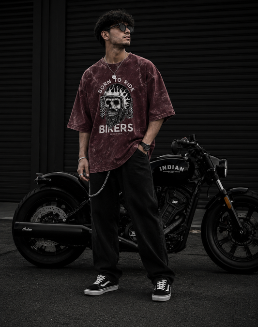 Zerofrom Born to Ride Oversized | 100% Cotton Acid Wash Person wearing a maroon t-shirt with a graphic design standing next to a motorcycle.
